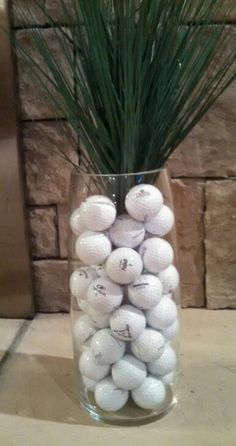 a vase filled with lots of white golf balls