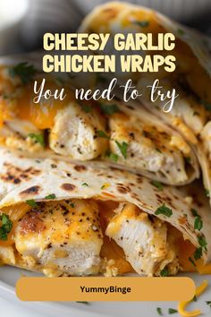 a white plate topped with chicken wrapped in tortilla wrappers and text that reads, cheesy garlic chicken wraps you need to try