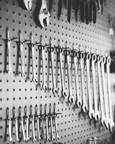 there are many wrenches hanging on the wall