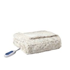 a white blanket with a remote control on the side and an electric cord attached to it