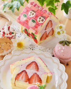 strawberry shortcakes are decorated with pink icing and flowers on a table next to a doll house