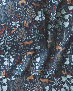 an animal print fabric with trees and animals on it's blue background is featured in this image