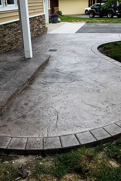 a concrete walkway in front of a house