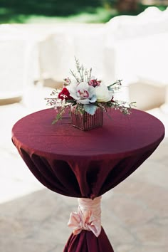 a table with a red cloth and flowers on it