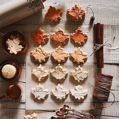 some cookies are sitting on a table next to cinnamon sticks and other items for baking