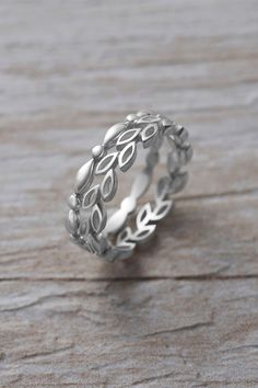 a silver ring sitting on top of a wooden table