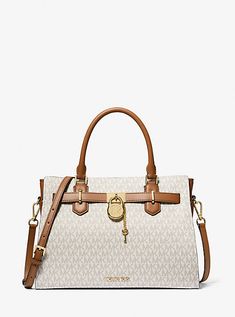 The Hamilton is a carefully crafted staple you’ll reach to for years to come. Defined by a polished padlock charm, this Signature-print satchel features a belted silhouette that can be adjusted in shape to fit all your essentials. Carry it by the top handle or attach the strap to wear it crossbody. Michael Kors Outlet, Media Logo, Bags Logo, Signature Print, Gorgeous Bags, Michael Kors Hamilton, Medium Bags, Beautiful Bags, Leather Satchel