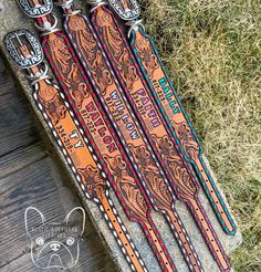 three leather skis are laying on the ground