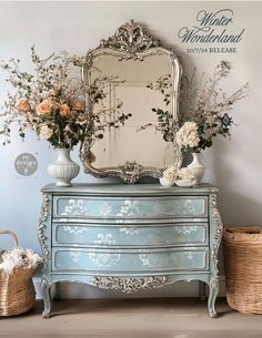 there is a dresser with flowers on it and a mirror