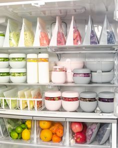 an open refrigerator filled with lots of different foods and containers in it's door