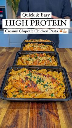 three pans filled with chicken and pasta on top of a wooden table next to a man