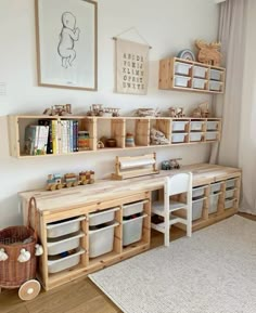 a child's playroom with toys and bookshelves on the wall next to a window