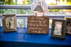 a blue table topped with pictures and framed photos