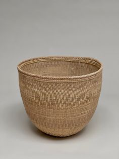 a woven basket is shown on a gray background