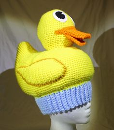 a knitted yellow ducky hat on a mannequin head