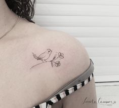 a woman with a bird tattoo on her shoulder