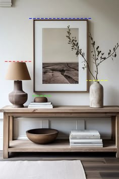 a wooden table with two vases on top of it and a lamp next to it