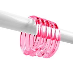 a white pole with pink glass rings attached to it's end, on a white background