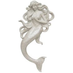 a white mermaid figurine sitting on top of a table