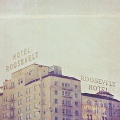 an old building with the word rosevelt written on it's side in front of other buildings