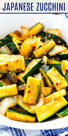 a white bowl filled with zucchini and other vegetables