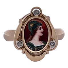 This is part of Chairish’s Costume Jewelry assortment.  This lovely ring with a detailed enamel portrait of Athena is detailed with 3 tiny Diamond in the surround. This is a small ring perfect for those ladies with smaller hands or as a pinky ring. This started life as a stick pin and I converted it to a ring as stickpins are no longer in style. This is all in 14K gold. These small portrait rings are very much in style and this is a wonderful example. The ring is set with 3 tiny Diamonds and a smooth back finish. It is sized 6.5 and weighs in at 5.70 grams. Do not wait this is waiting for you. Small Ring, Tiny Diamond, Lovely Ring, Small Rings, A Stick, Pinky Ring, Gold Enamel, Small Hands, Signet Ring