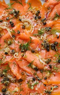 salmon and olives on a plate with herbs