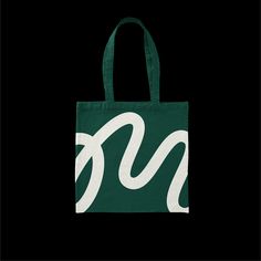 a green tote bag with the letter n on it's side and white letters