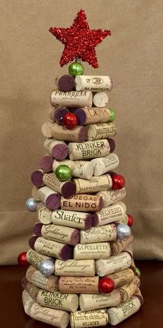 a christmas tree made out of wine corks with a red star on the top