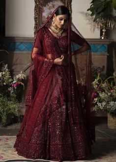 Editor's Note Featuring A Burgundy Lehenga In Net Base With Thread, Cutdana, Sequins Embroidery. It Is Paired With Matching Blouse And Net Base Two Dupattas. Color: Burgundy Fabric: Net Care: Dry Clean Only About the Designer Megha And Jigar Came Together To Infuse The Unique Blend Of Embellishment With Rich Colors, Delicate Forms With The Structure To Create A Label With An Aesthetic That Is Traditional And Royal In Its Treatment Yet With A Contemporary Modern Touch. The Use Of Rich Fine Fabric Burgundy Lehenga, Maroon Wedding Dress, Red Wedding Lehenga, Maroon Lehenga, Chic Prom Dresses, Net Embroidery, Indian Bride Outfits, Burgundy Fabric