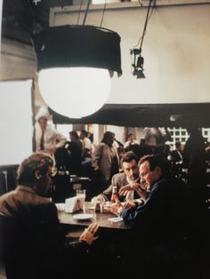 two men sitting at a table in a restaurant