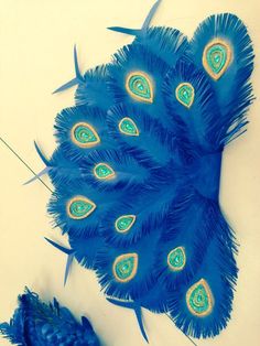 a blue peacock feather is laying on the floor