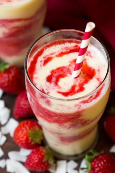 strawberry colada smoothie in a glass with strawberries around it and text overlay that reads, strawberry colada smoothie