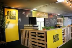 the food stand is decorated with yellow and black signs