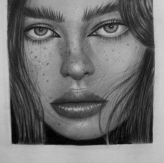 a pencil drawing of a woman's face with freckles