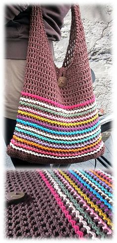 a crocheted bag sitting on top of a table next to a knitted blanket