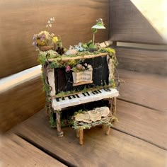 an old piano with moss growing on it