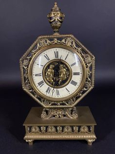 an antique clock with two lions on it's face is shown against a black background