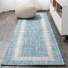 a blue and white rug in a living room