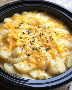 a black bowl filled with macaroni and cheese