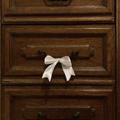 a drawer with a white bow on it