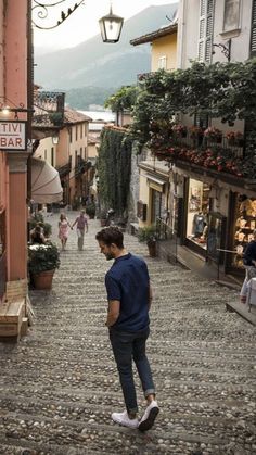 a man walking down a cobblestone street