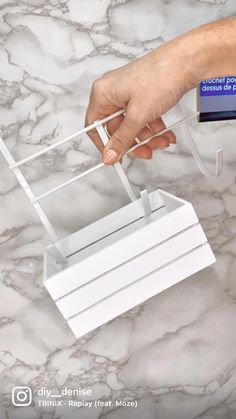 a person is pulling something out of a box on a marble counter top with their hand