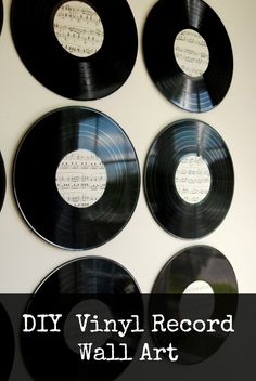 four black and white records with sheet music on them are arranged in a wall display