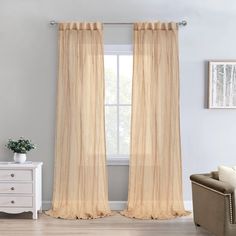 a living room with white furniture and beige curtains