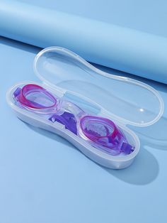 two pairs of goggles sitting in a plastic case on a blue surface with the lid open