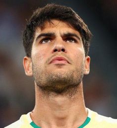 a close up of a soccer player with his eyes closed and head tilted to the side