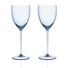 two empty wine glasses sitting next to each other