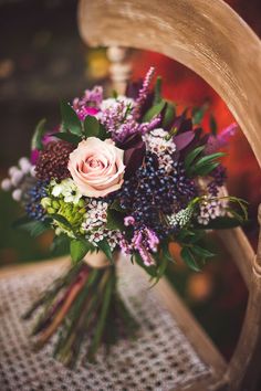 a bouquet of flowers sitting on top of a wooden chair