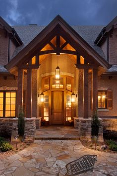 the front entrance to a home lit up at night